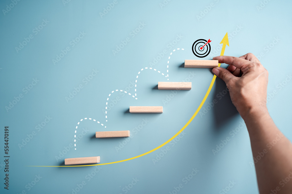 Business growth success achievement concept, hand arranging wooden block stacking as step stair or ladder for planning development leadership and customer target group concept..